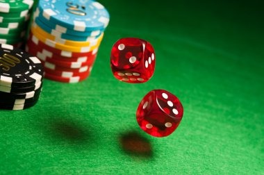 Professional dealer in HD studio setting, smiling at camera with cards and chips visible